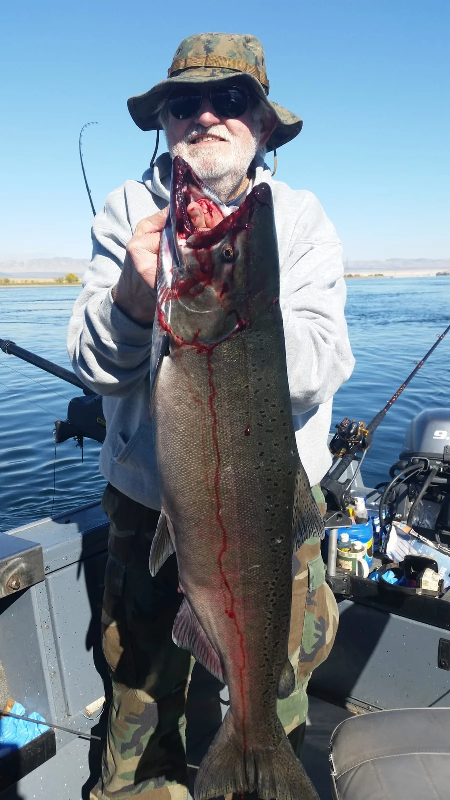 Bearded man in a bucket hat holding a long Chinook