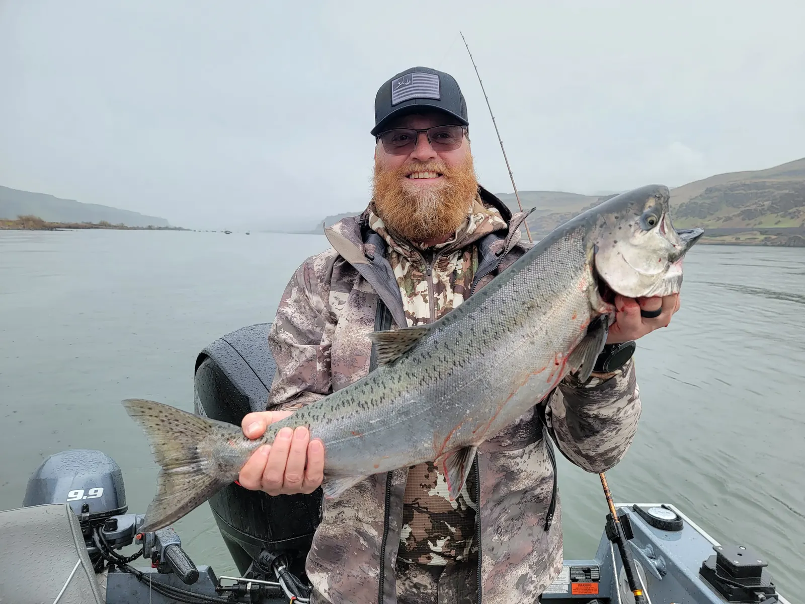 Bearded angler holding a spring Chinook salmon